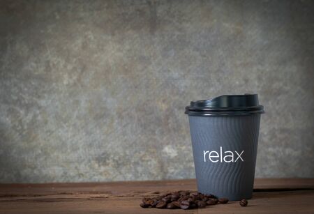 Hot coffee on wooden table with coffee beanの写真素材