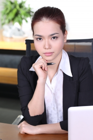 Young business woman working at office, think and look awayの写真素材