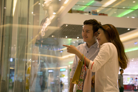 Young Asian happy couple shoppingの写真素材