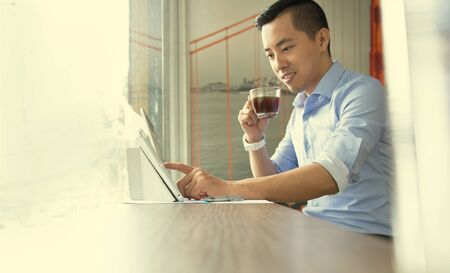Asian casual business man working in coffee shop