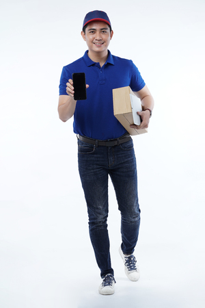 Handsome man delivery in blue uniform with packages isolated on whiteのeditorial素材