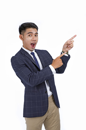 Asian handsome young business man with hand and finger showing isolated on white background with copy spaceの写真素材