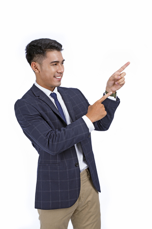 Asian handsome young business man with hand and finger showing isolated on white background with copy spaceの写真素材