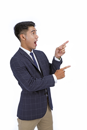 Asian handsome young business man with hand and finger showing isolated on white background with copy spaceの写真素材
