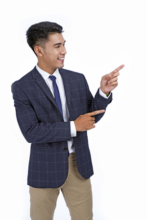 Asian handsome young business man with hand and finger showing isolated on white background with copy spaceの写真素材