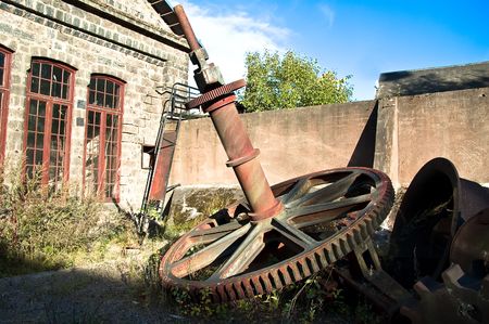 Cogwheel and old factory building