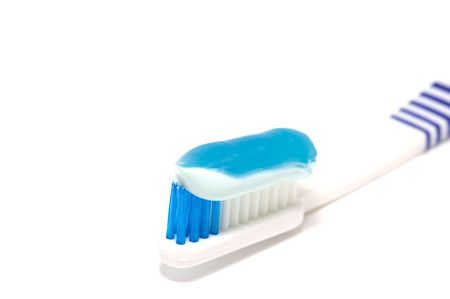Toothbrush with toothpaste on white background