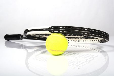 Tennis ball with a detailed racquet lying on itの写真素材