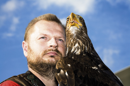 Falconer and bald eagle close upの写真素材