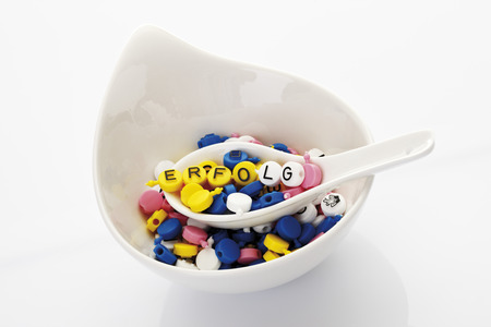 Letters on spoon in soup bowl forming the word successの写真素材