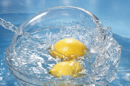Water splashing on fresh lemonsの写真素材