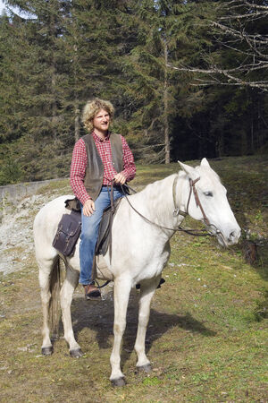 Austria, Salzburger Land, Altenmarkt, young man sitting on horsebackの写真素材