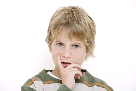 Little boy, hand to chin, portraitの写真素材