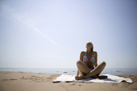 Young woman sunbathing on beachの写真素材