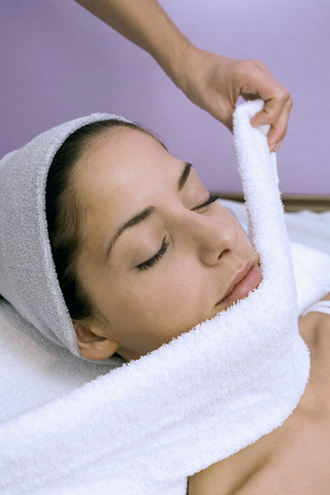 Young woman receiving facial treatmentの写真素材