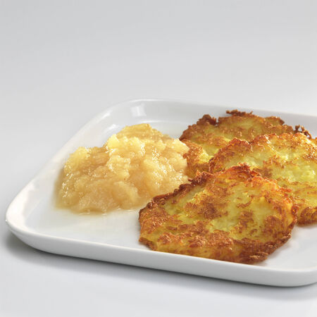 Potato fritters with apple sauce on plateの写真素材