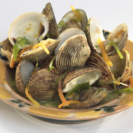 Clam shells in white-wine sauce and root vegetablesの写真素材