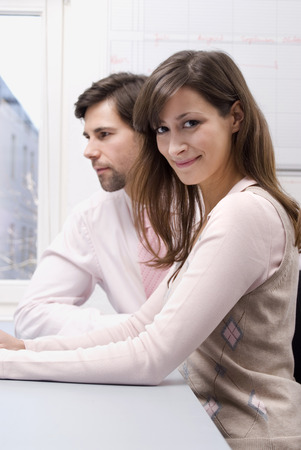 Businessman and woman in officeの写真素材