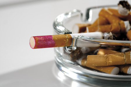 Ashtray full of burnt cigarettesの写真素材