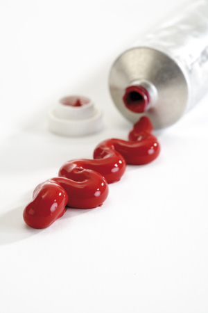 Paint tube and red colorの写真素材