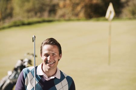 Italy, Kastelruth, Man on golf course smiling