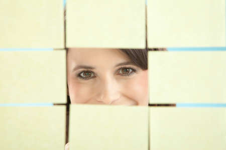 Businesswoman looking through adhesive notes