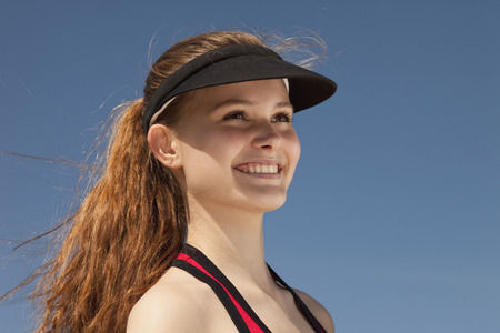Germany, Bavaria, Teenage girl looking away, smilingの写真素材