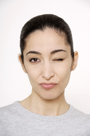 Young woman winking, portrait,の写真素材