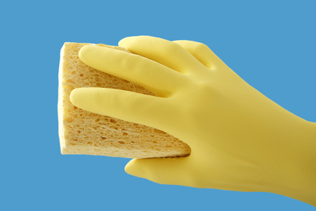 Hand holding sponge, close upの写真素材