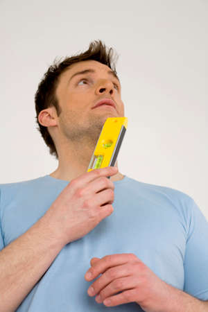 Young man with yellow spirit level,low angle view