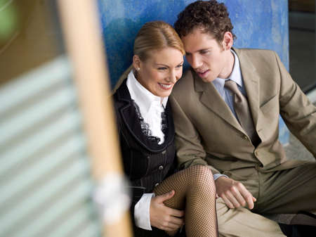 Businesswoman and businessman sitting, smilingの写真素材