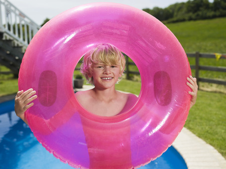 Boy playing with inflatable tire on beach