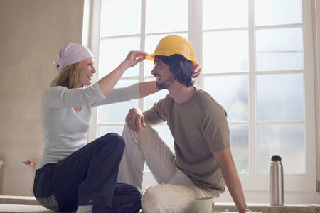 Young couple on construction site having fun