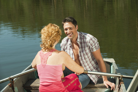 Italy South Tyrol couple sitting in rowing boat smilingの写真素材