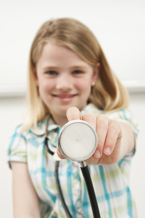 Girl holding stethoscope smiling depth of fieldの写真素材