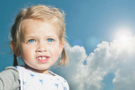 Germany, Cologne, young girl portrait with skyの写真素材