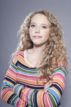 Dissatisfied teenage girl with arms crossed and looking awayの写真素材