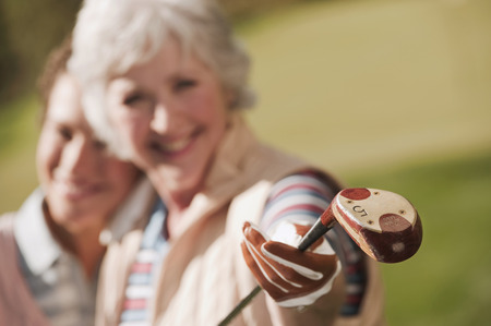 Italy, Kastelruth, Golfers on golf course smilingの写真素材