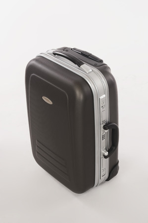 Silver and black suitcase against white backgroundの写真素材