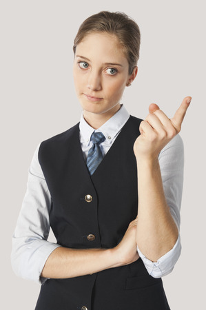 Close up of angry young air hostess pointingの写真素材