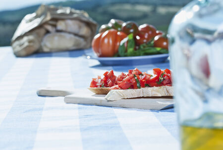 Italy, Tuscany, Magliano, Bruschetta, bread, tomatoes and olive oil on table