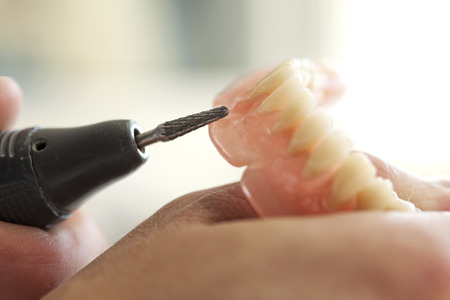 Dental technician  working in dental laboratory