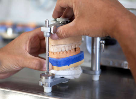 Dental technician  working in dental laboratoryの写真素材
