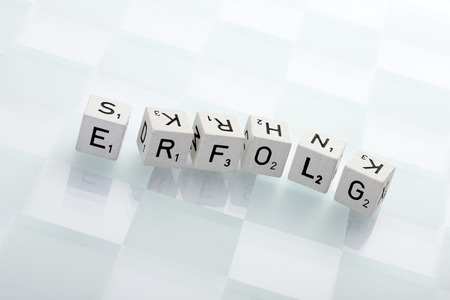 Dices on chess board forming the word success