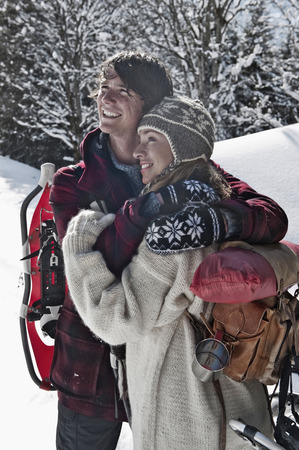 Austria, Salzburger Land, Couple in snowy landscape looking awayの写真素材