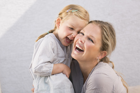 Mother and daughter cheek to cheek