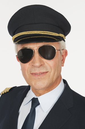 Close up of senior flight captain on white backgroundの写真素材