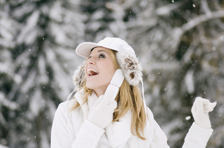 Austria, Salzburger Land, Altenmarkt, Young woman fooling around in the snowy woods