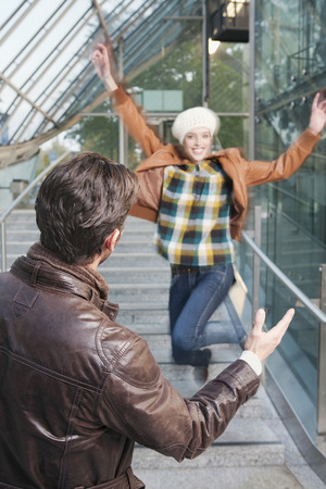 Germany, Bavaria, Munich, couple woman jumping on stairs smilingの写真素材
