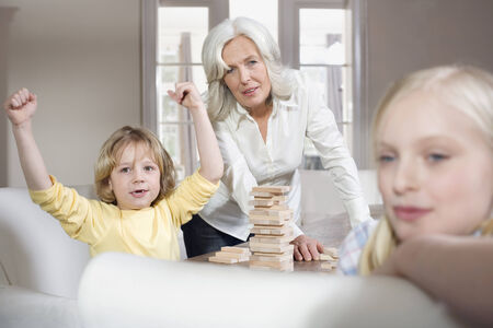 Grandmother and grandchildren playing with engage togetherの写真素材